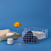 Lilac grid baskets with yarn and stationery. a basket with art supplies, and an orange lamp