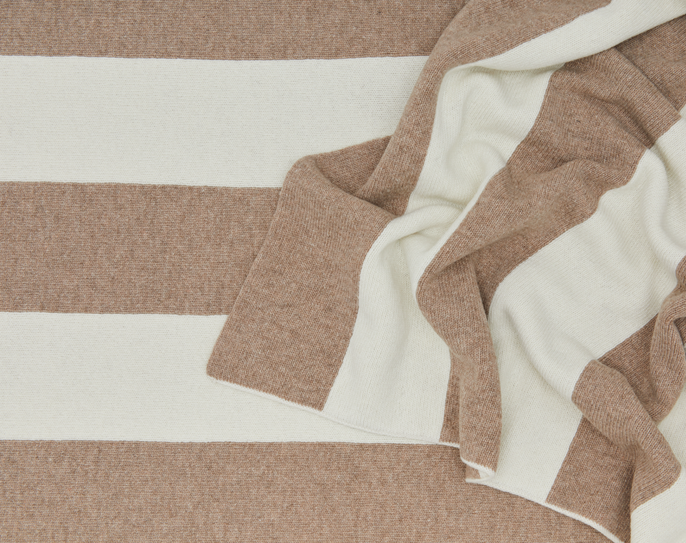Close-up of a brown and white striped throw.