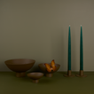 A trio of footed bowls and pair of candle holders, all in Olive, with green taper candles. Styled with a butterfly.