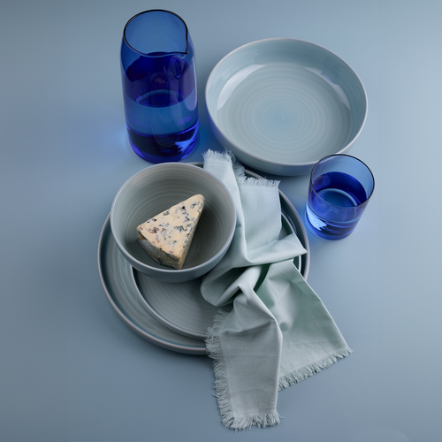 Essential dinnerware, glassware, pitcher, and napkins in Sky tones.