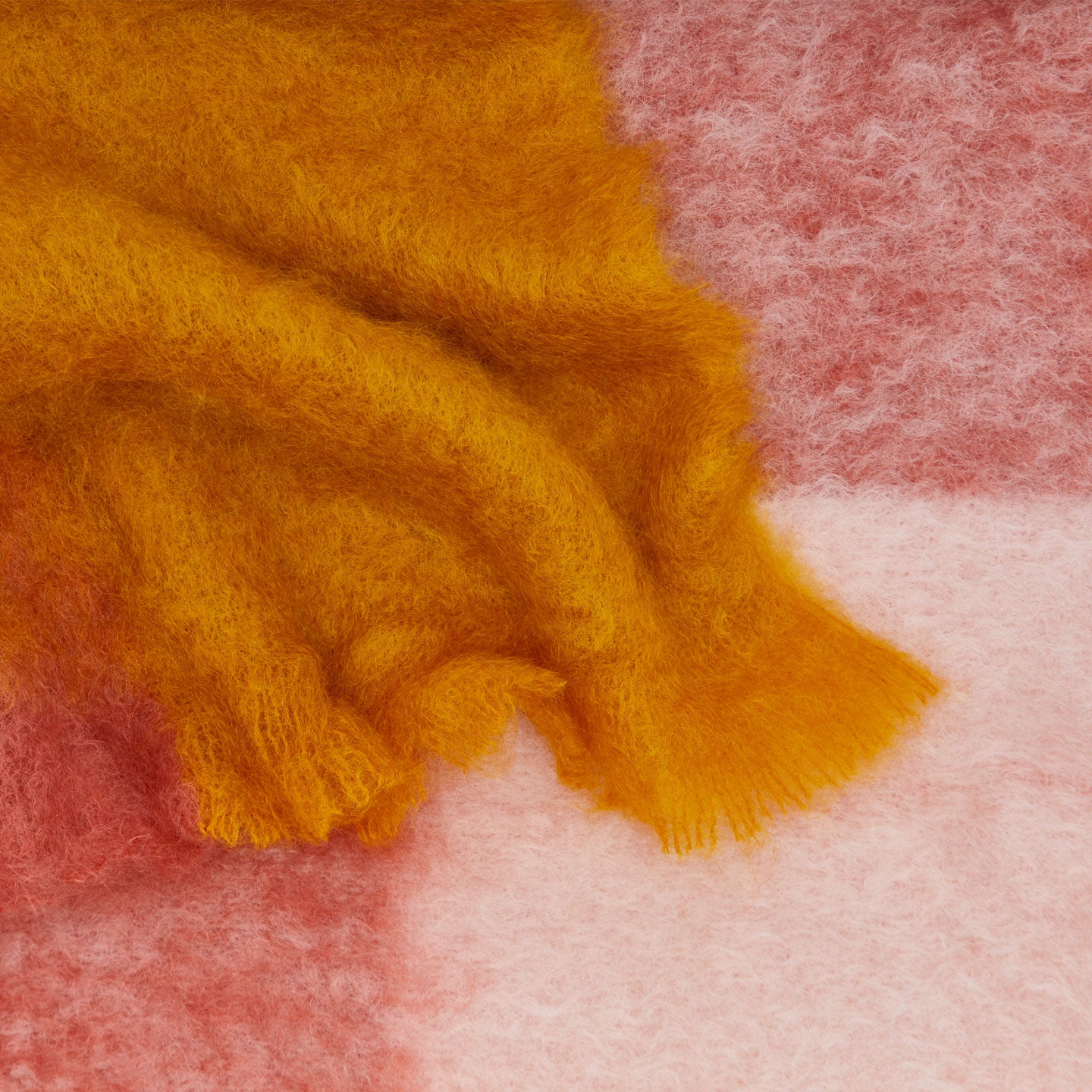 Texture detail of Exploded Plaid Mohair Throw in warm tones. 