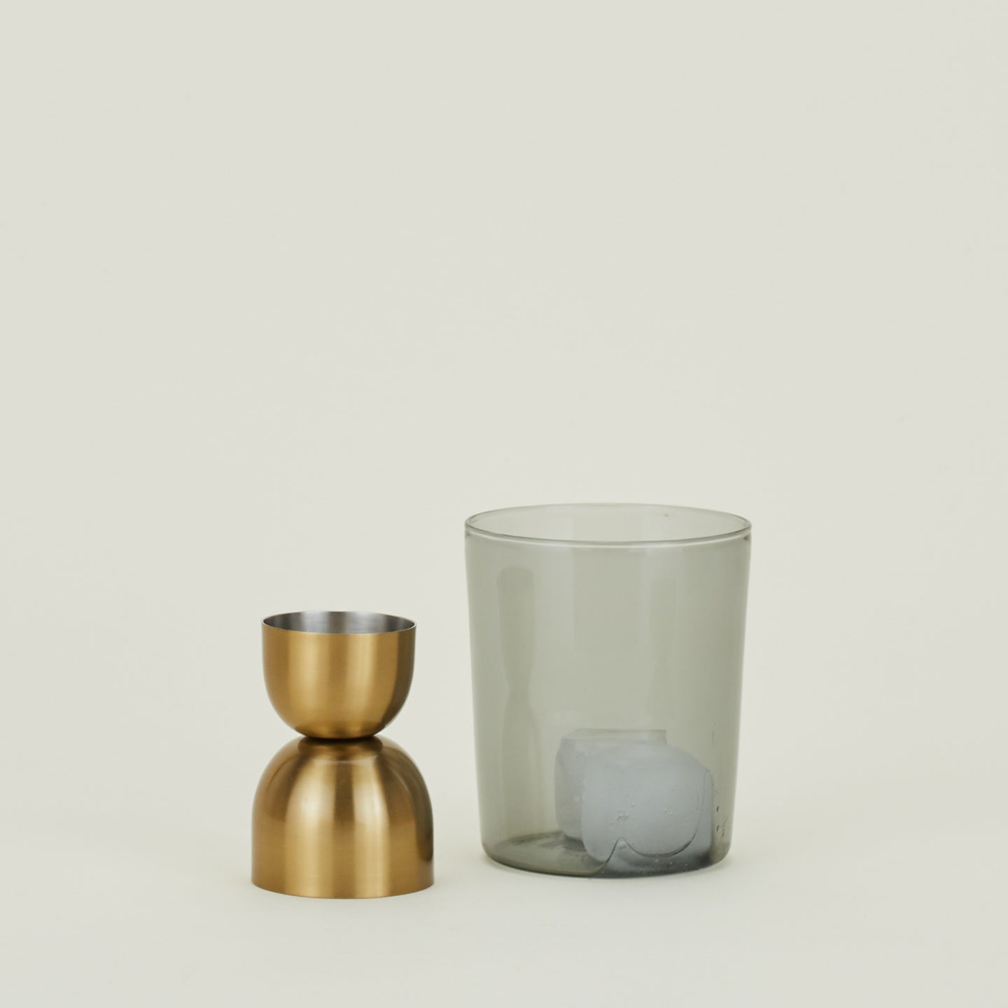 Brass jigger and Essential Smoke Glass with ice.
