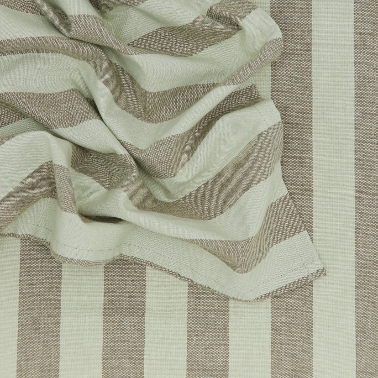 Close up of Essential Striped Dinner Napkin in Olive and Sage.