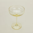 Close up of ribbed amber cocktail coupe glass.
