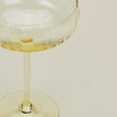 Close up of ribbed amber cocktail coupe glass.