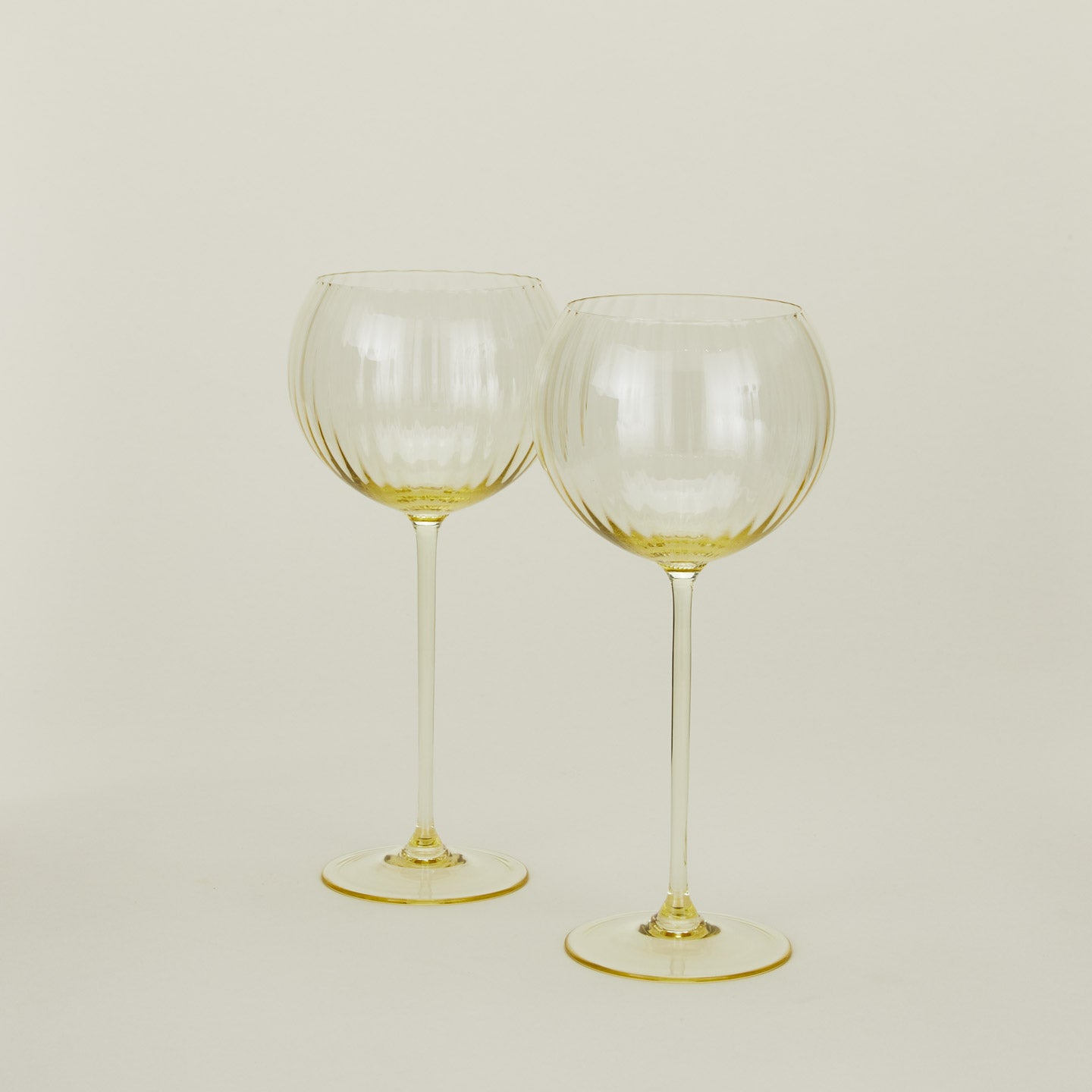 Set of two ribbed amber wine glasses.