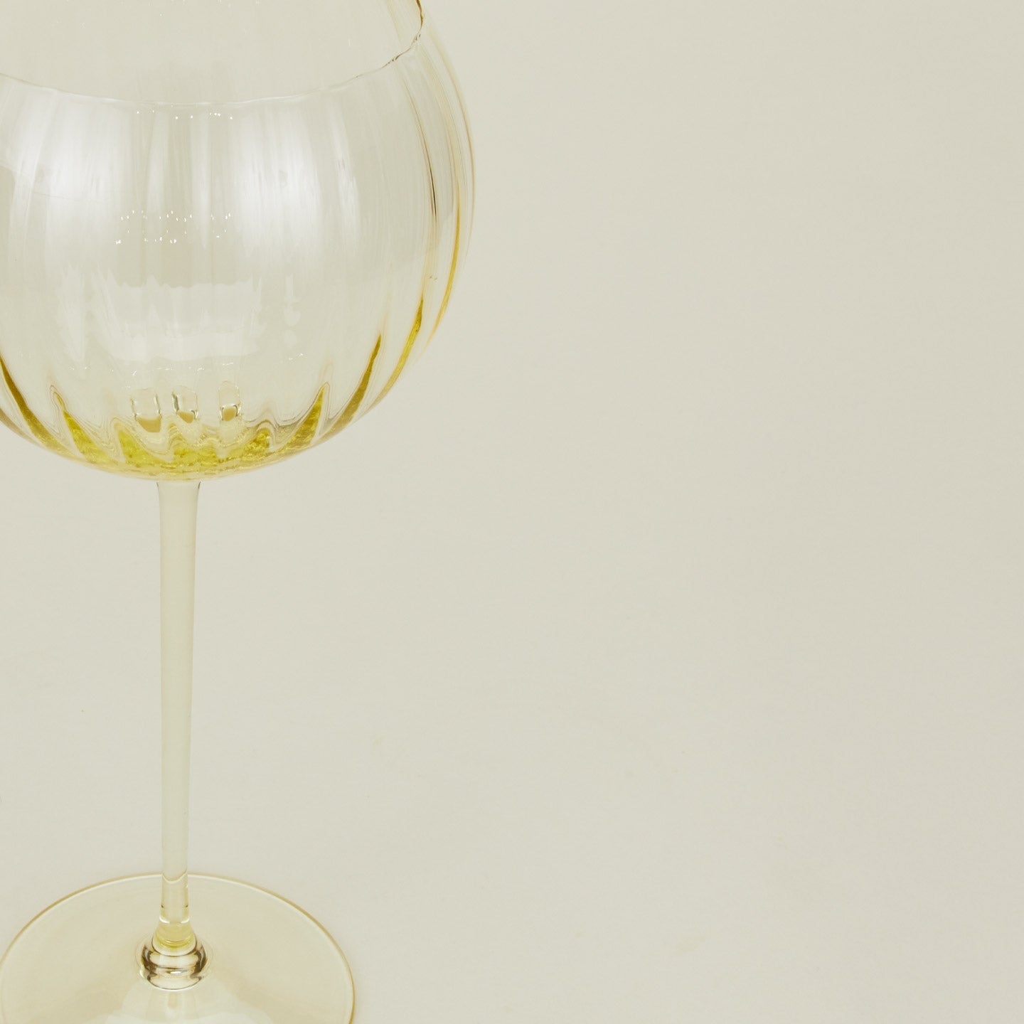 Close up of ribbed amber wine glass.