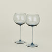 Set of two ribbed blue wine glasses.