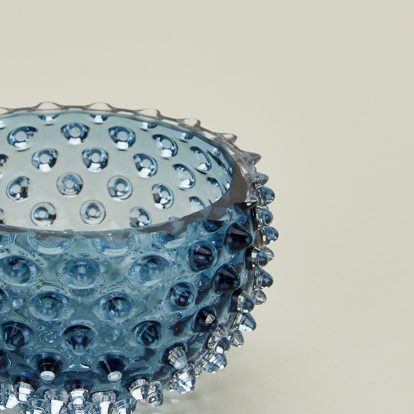 Close up of glass hobnail blue tapas bowl.