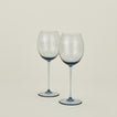 Set of two ribbed blue wine glasses.