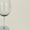 Close up of ribbed blue wine glass.