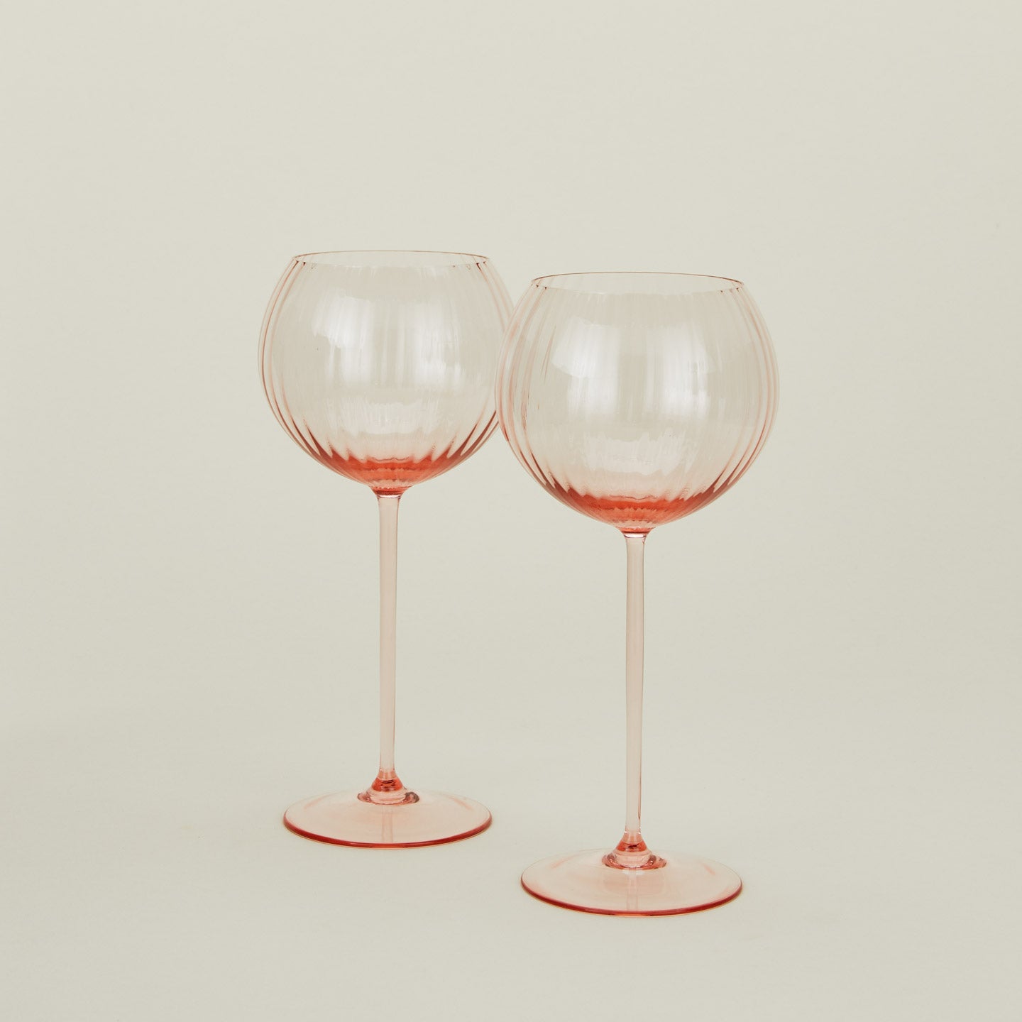 Set of two ribbed blush wine glasses.