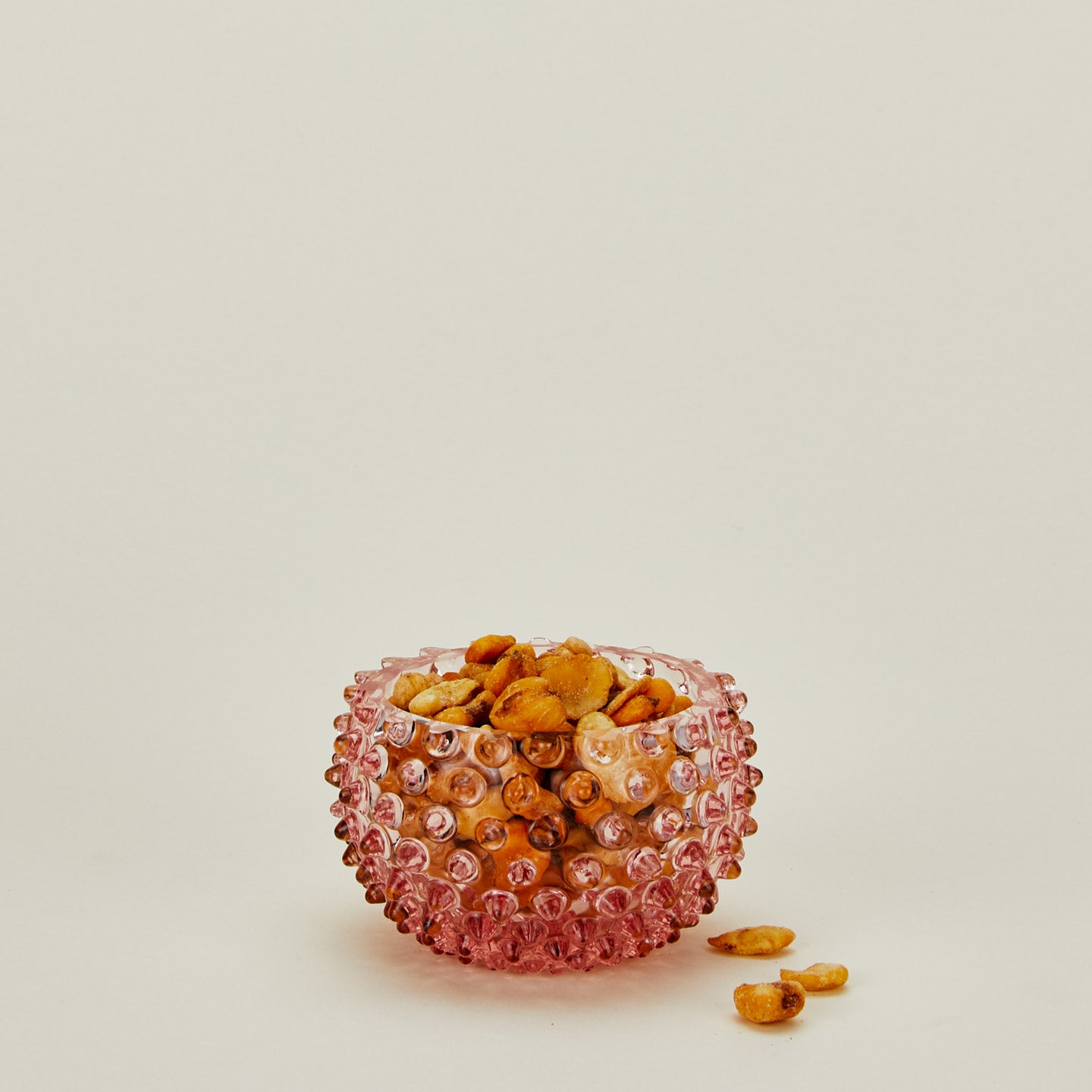 Glass hobnail blue tapas bowl with snacks.