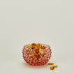 Glass hobnail blue tapas bowl with snacks.