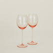 Set of two ribbed blush wine glasses.