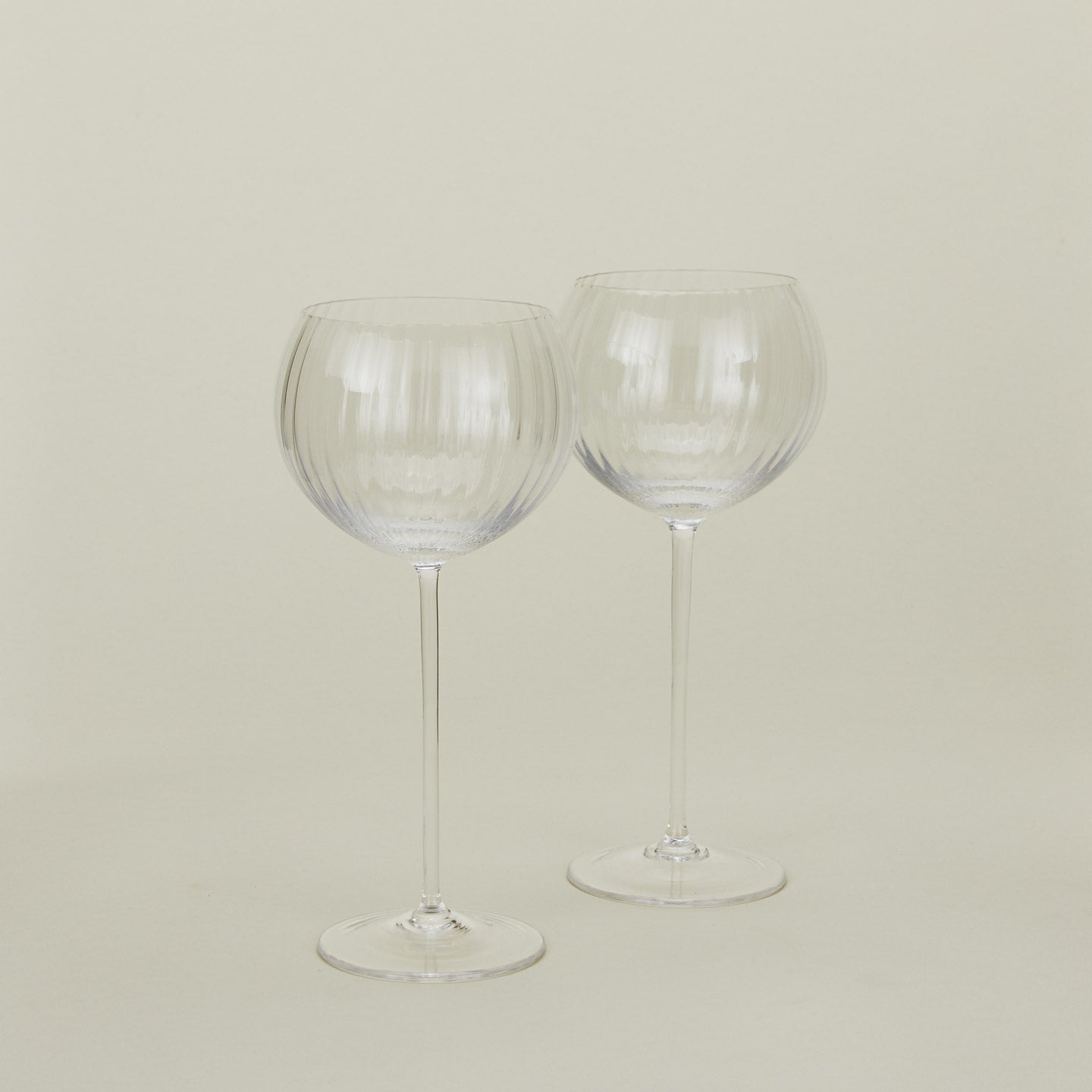 Set of two ribbed clear wine glasses.