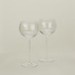 Set of two ribbed clear wine glasses.