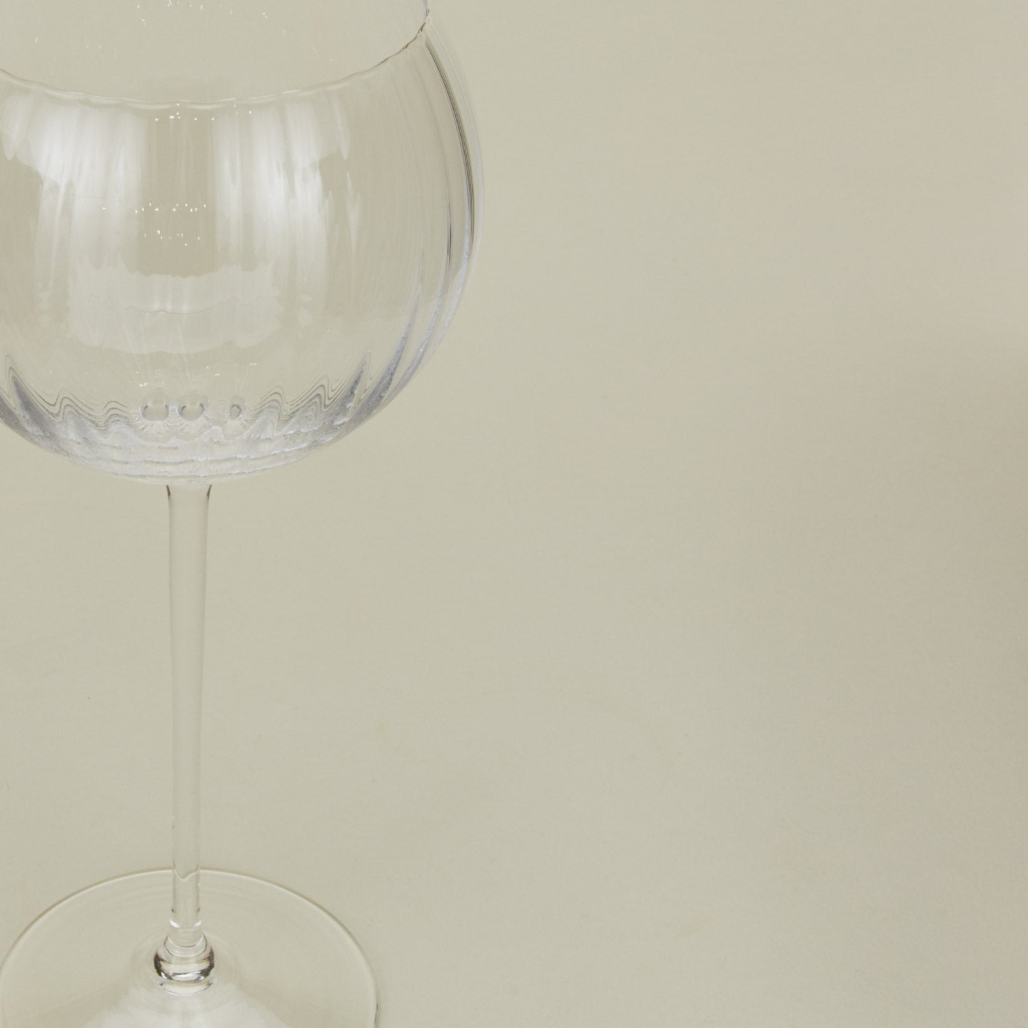 Close up of ribbed clear wine glass.