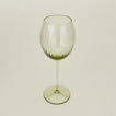 Three-quarter angle of ribbed olive wine glass.