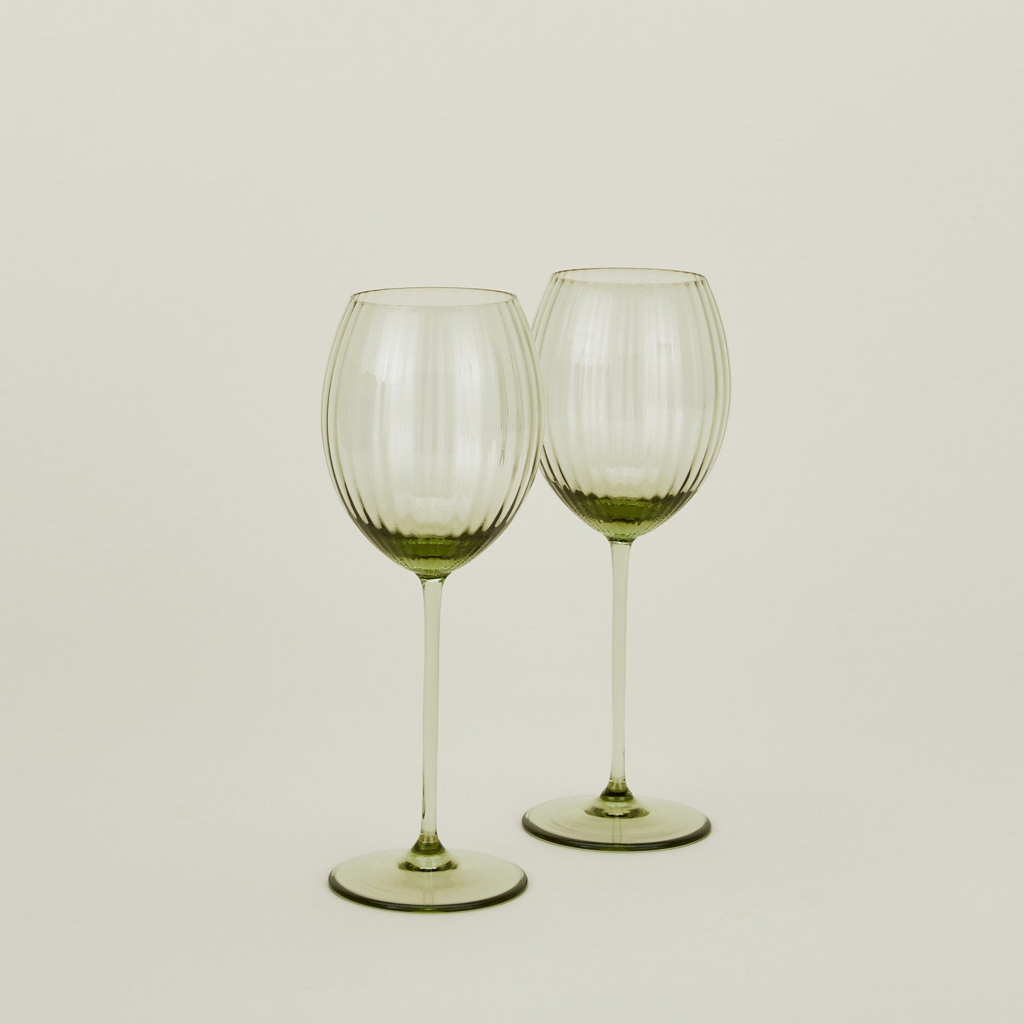 Set of two ribbed olive wine glasses.