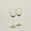 Set of two ribbed olive wine glasses.