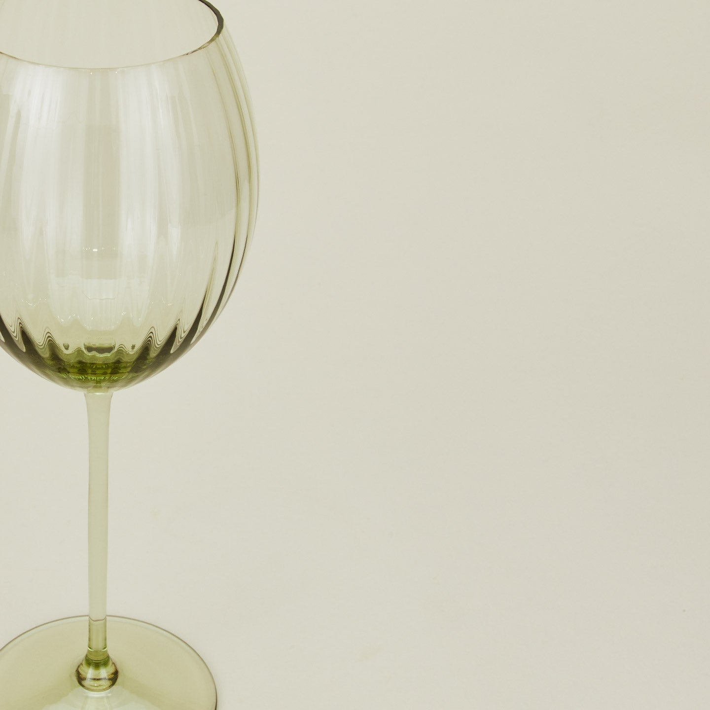 Close up of ribbed olive wine glass.