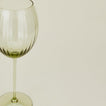 Close up of ribbed olive wine glass.