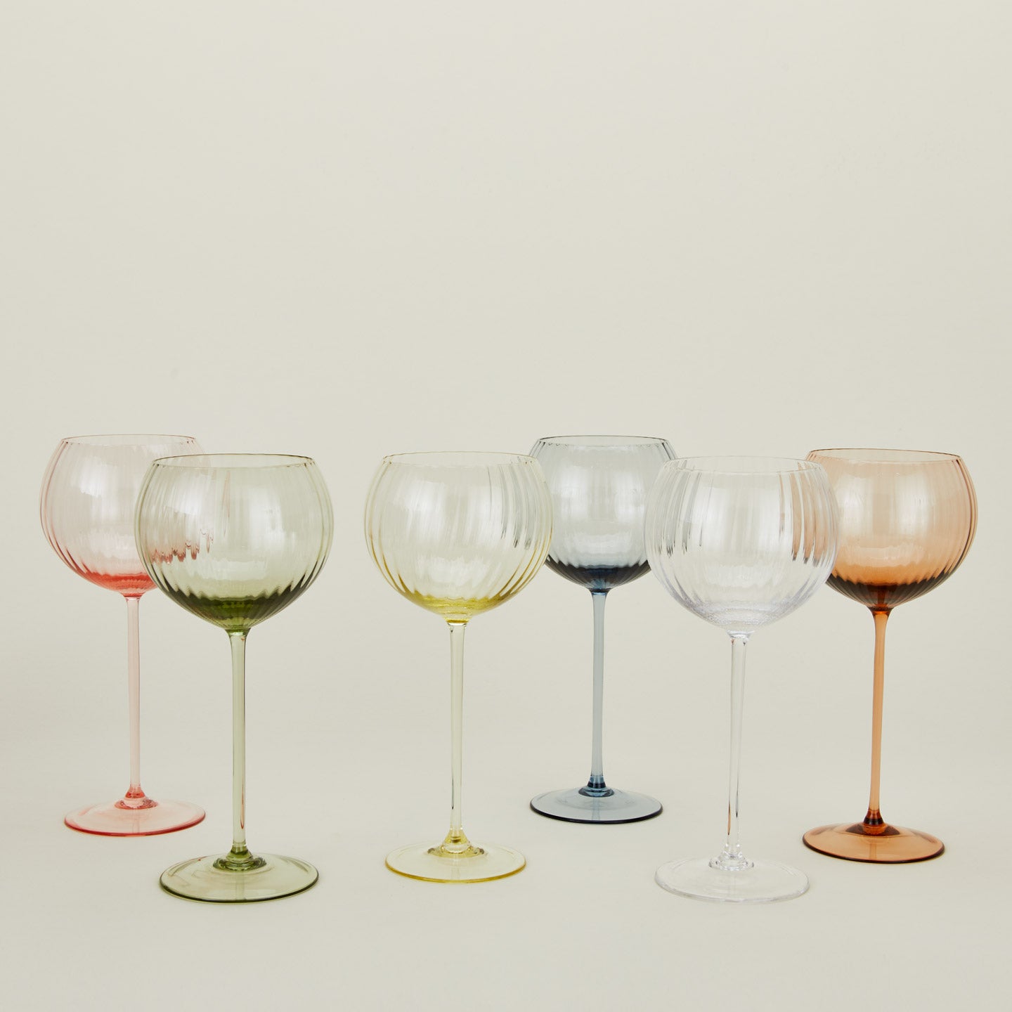 Red wine glasses in a variety of colors.