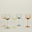 Red wine glasses in a variety of colors.