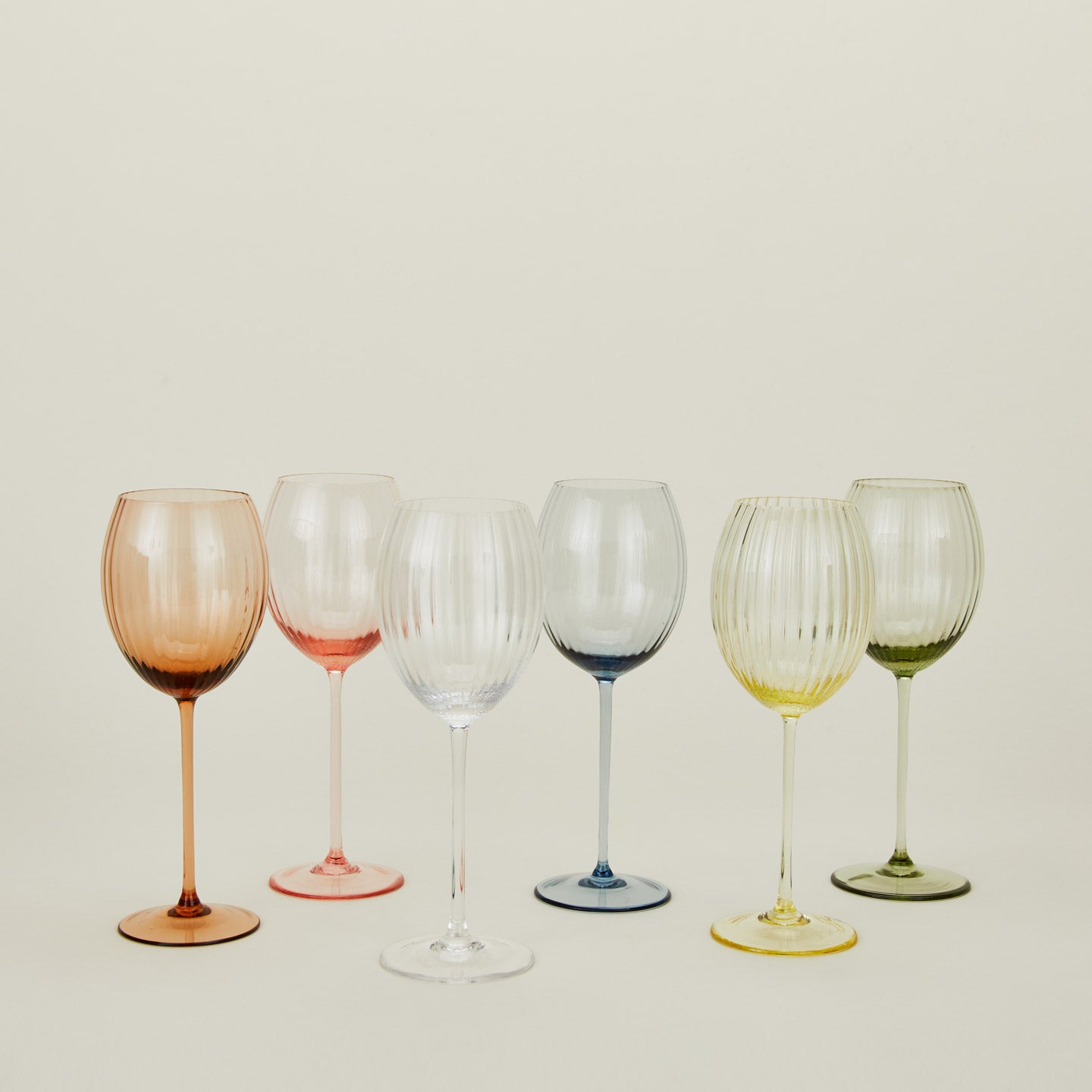 White wine glasses in a variety of colors.