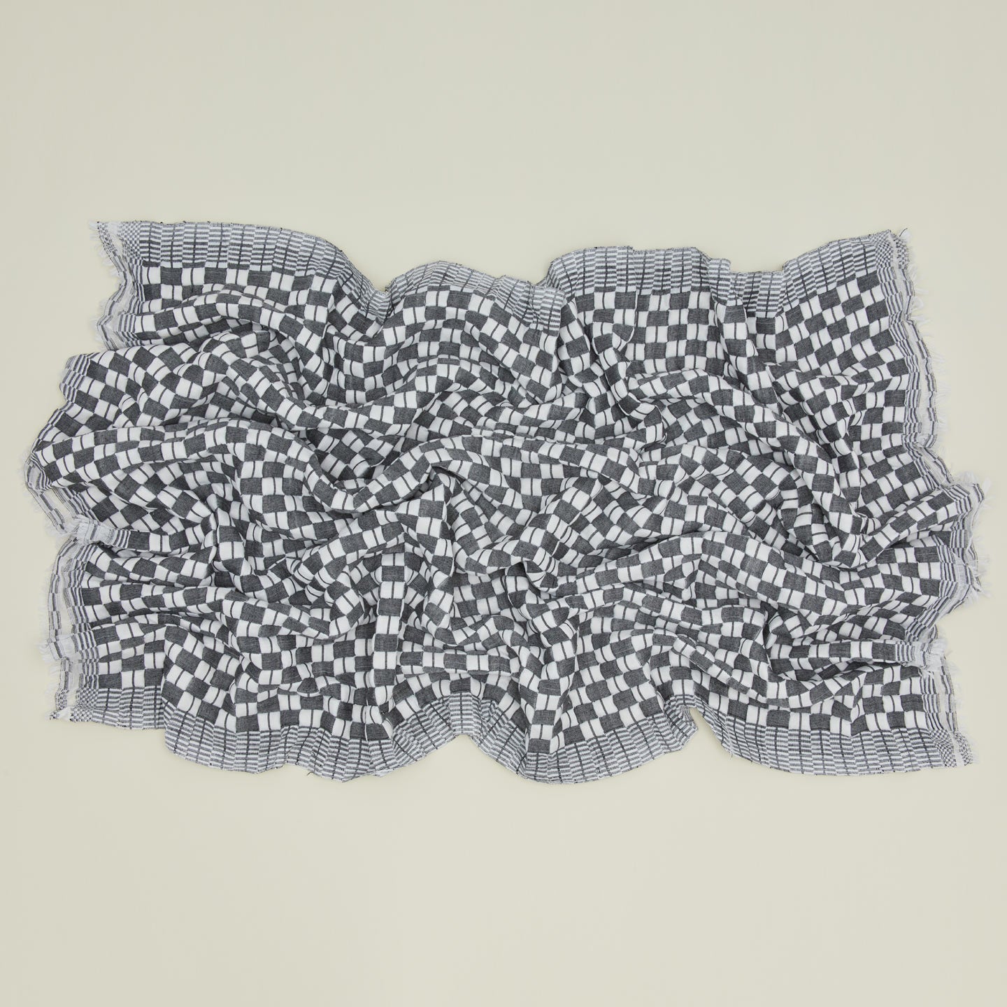 Quilted checkered throw in black and white, open.