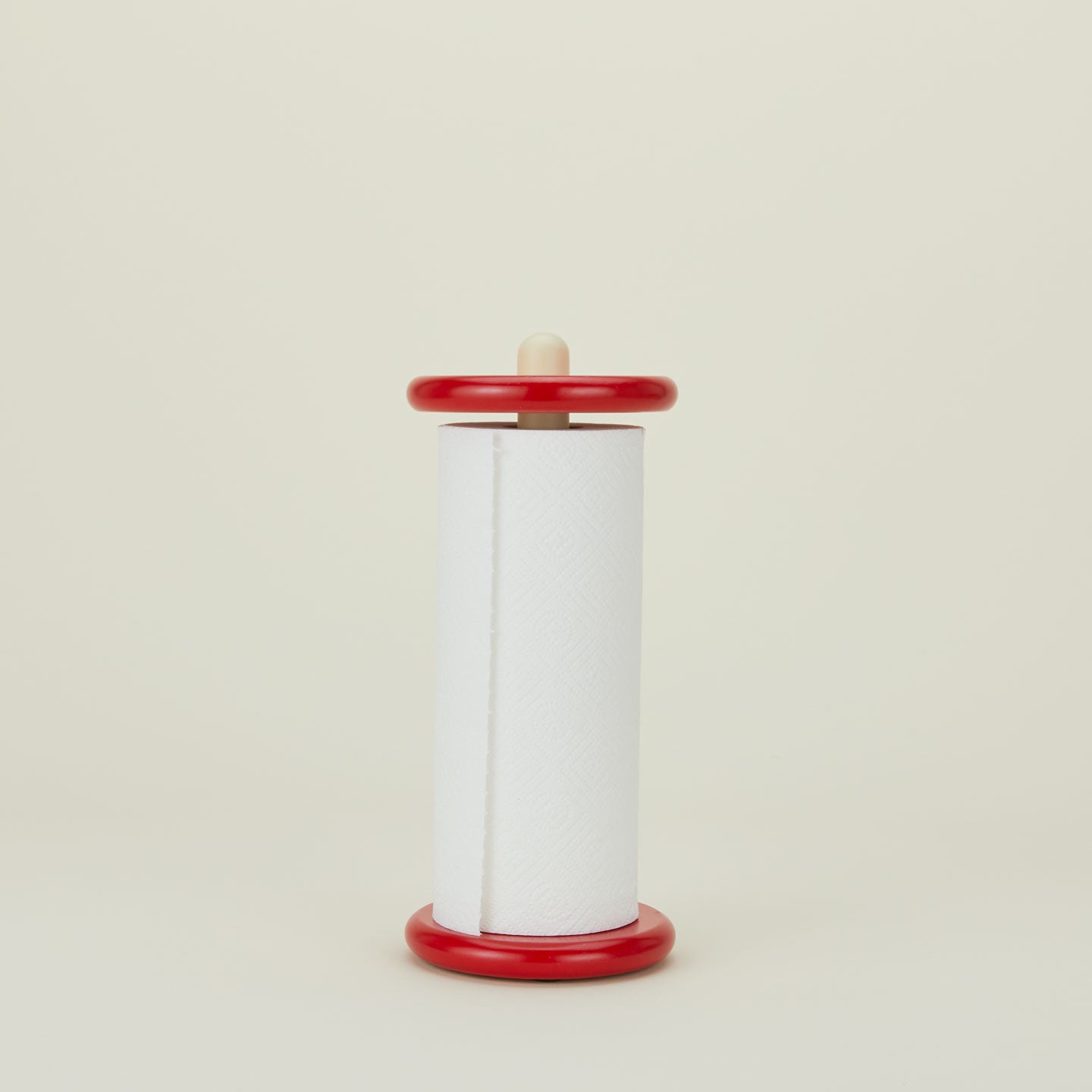 A red and yellow paper towel holder with paper towel roll.