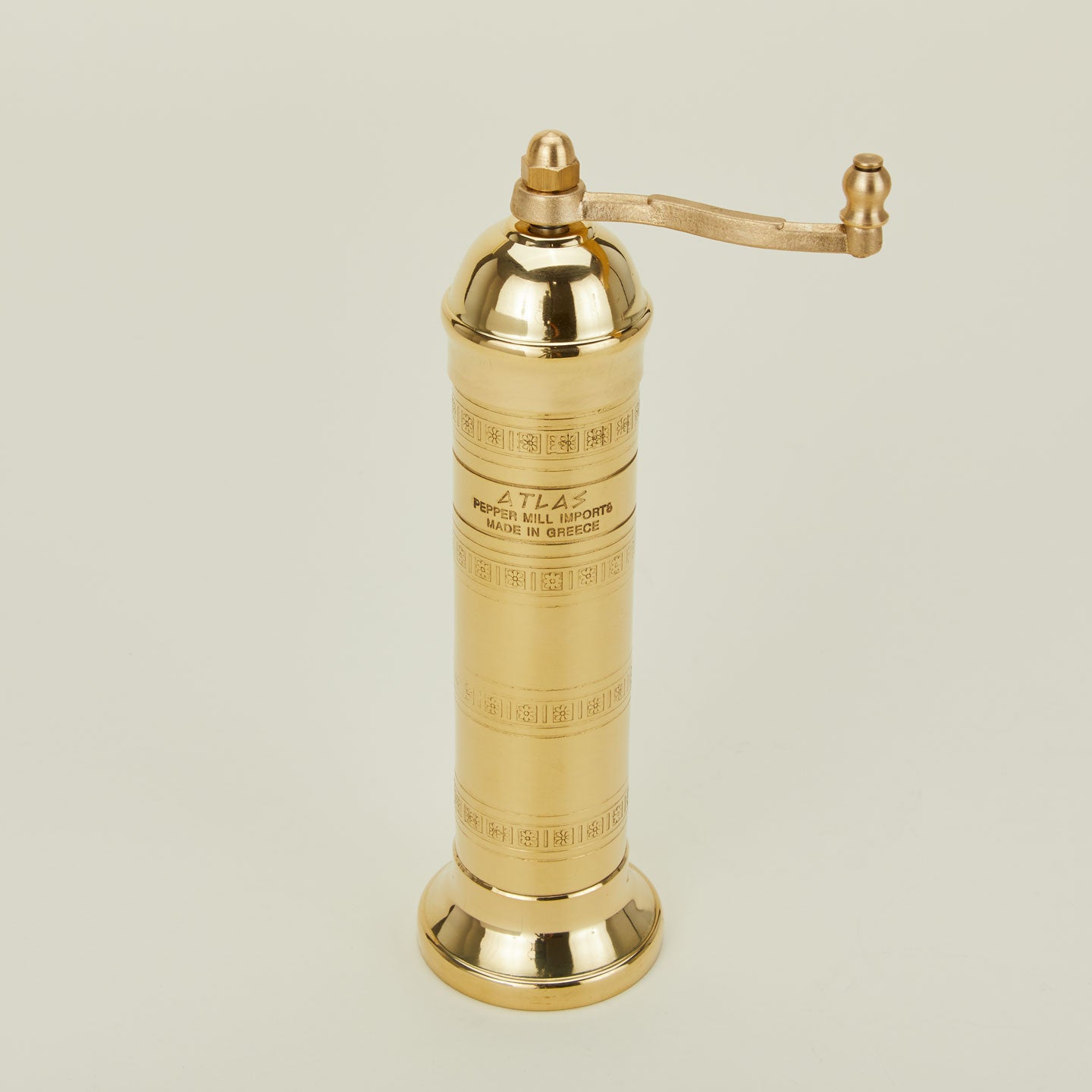 A close up of a brass salt mill.