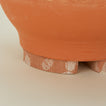Detailed view of Terracotta planter feet.