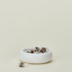 Concave ceramic bowl in white with candy