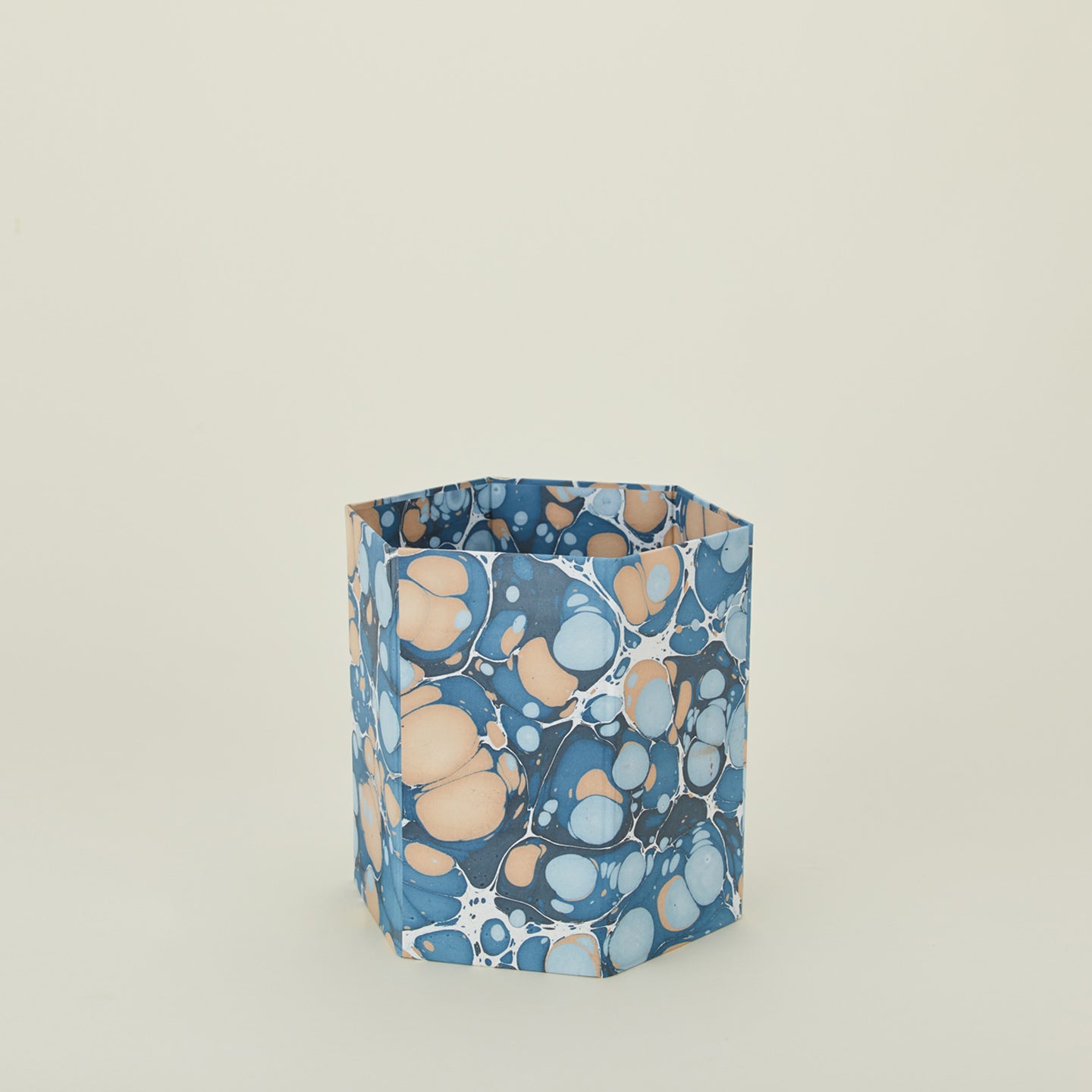 Marbled hexagon wastebasket in cool tones.