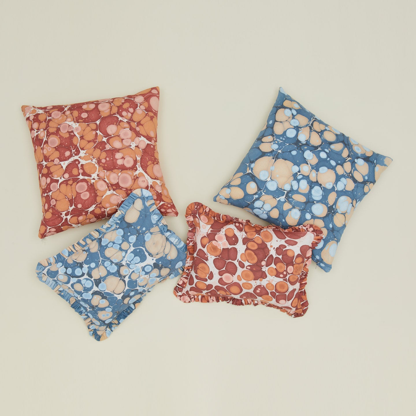 Marbled pillows in various shapes and colors.