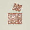 Overhead view of two scalloped marbled trays in mocha.