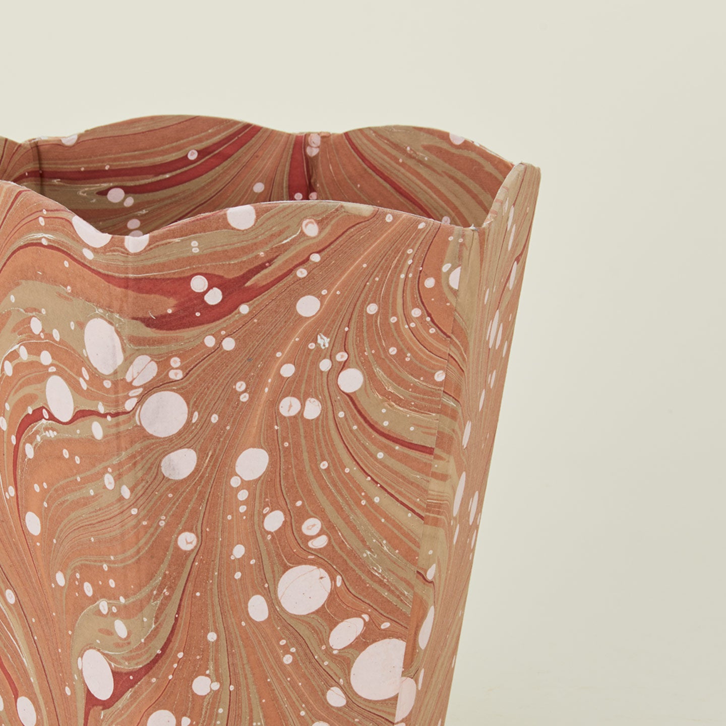 Detail of marbled scalloped wastebasket in mocha.