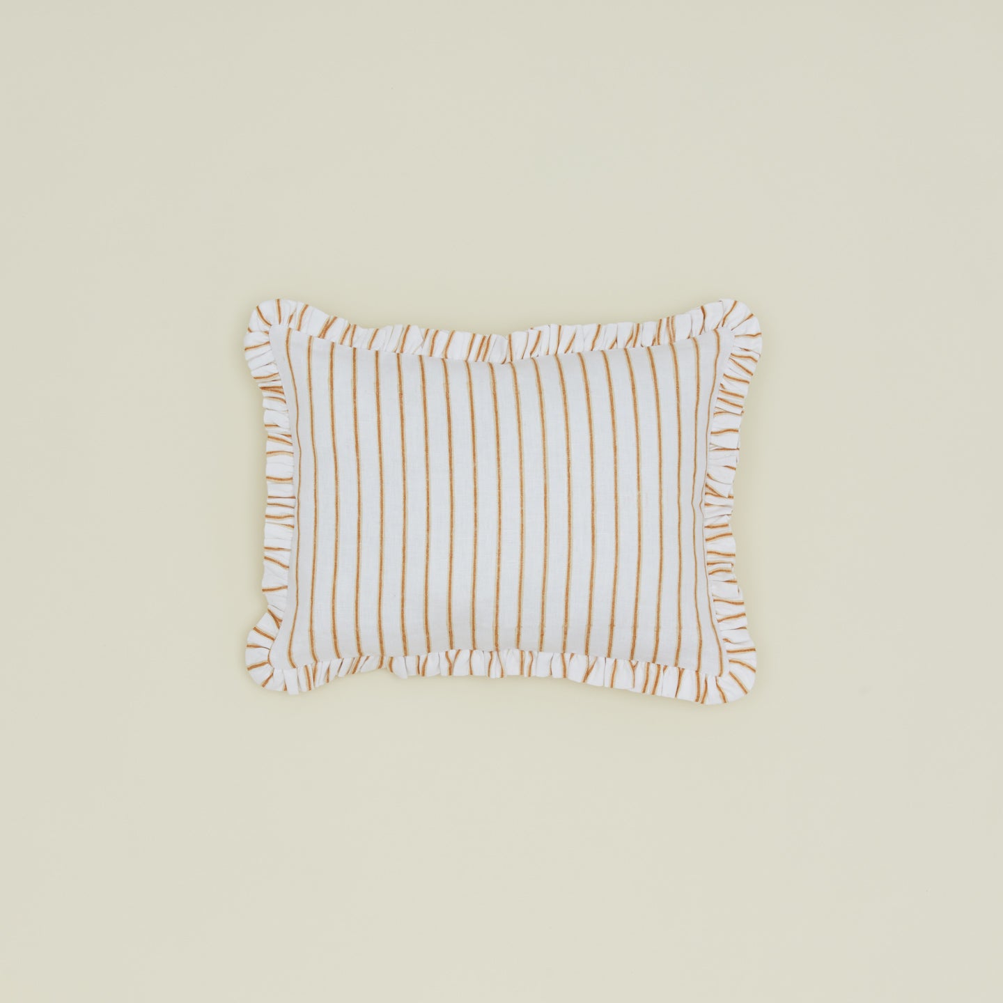 Block printed striped ruffled pillow in Tan.