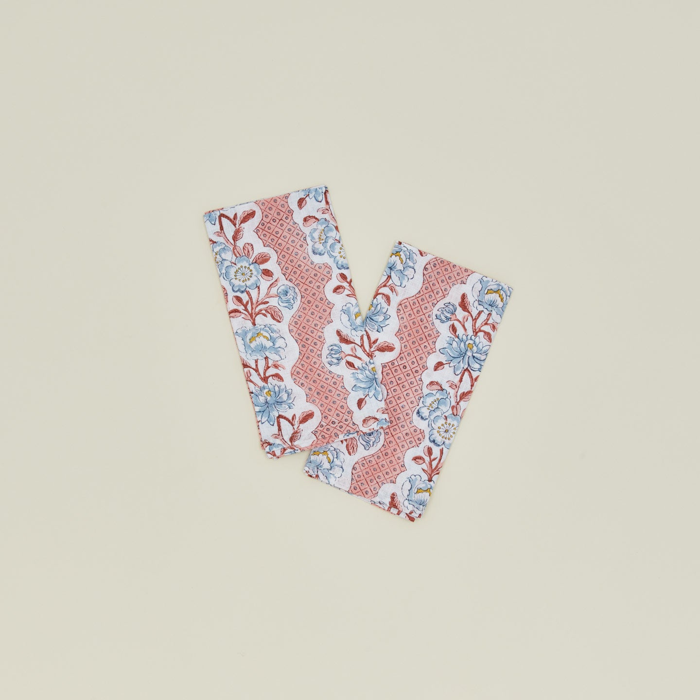 A set of two block printed napkins with a floral pattern in blush.