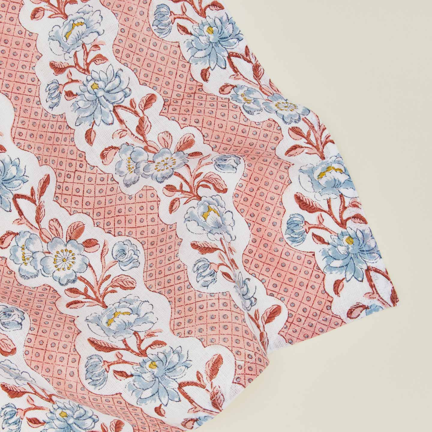 Detail of block printed napkin with a floral pattern in blush.