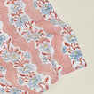 Detail of block printed napkin with a floral pattern in blush.