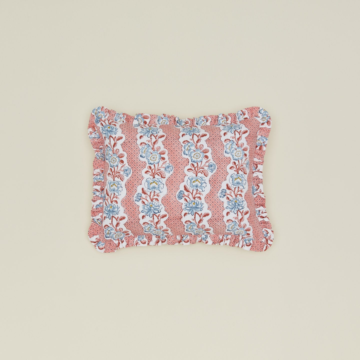 Block printed floral ruffled pillow in blush.