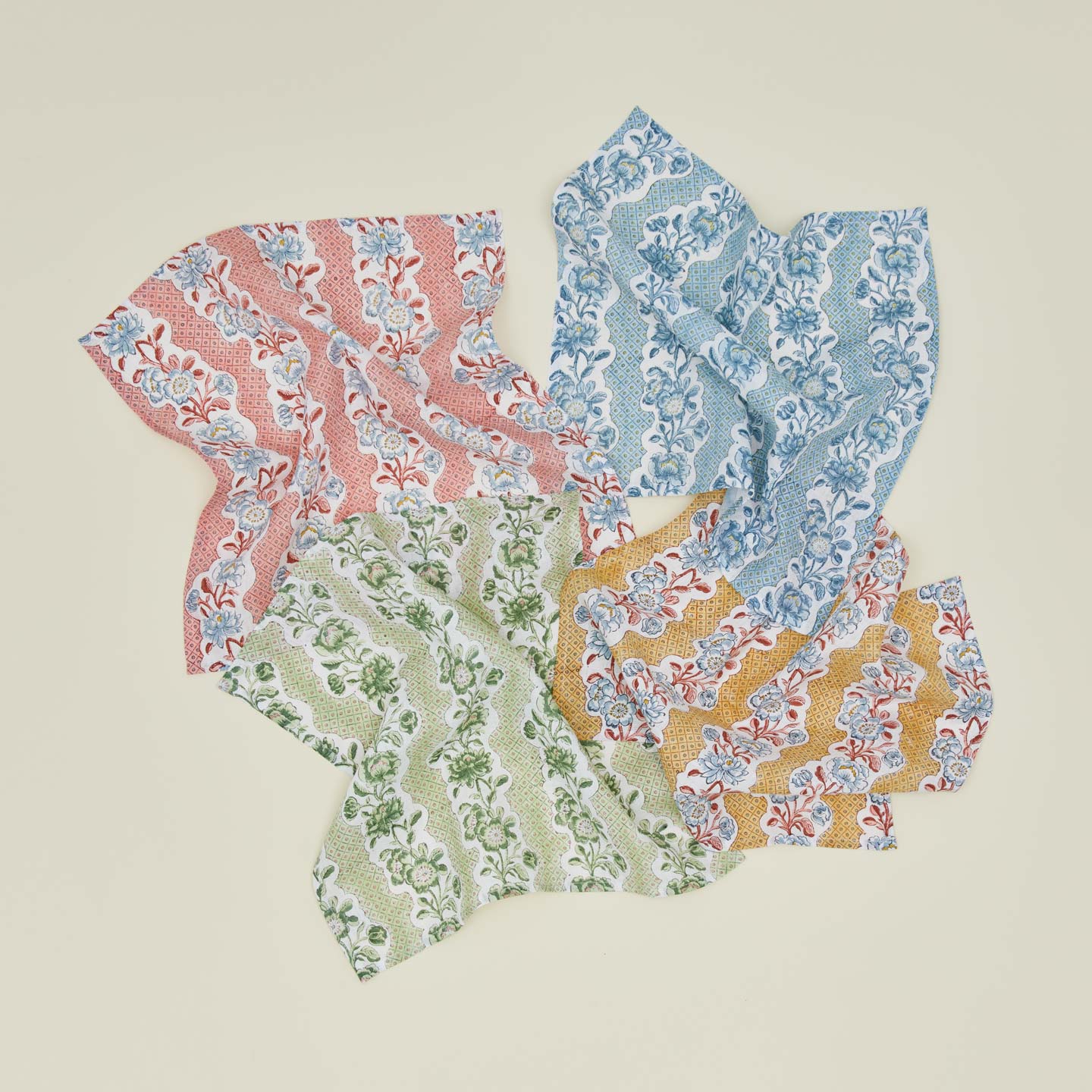Unfolded floral block printed napkins in various colors.