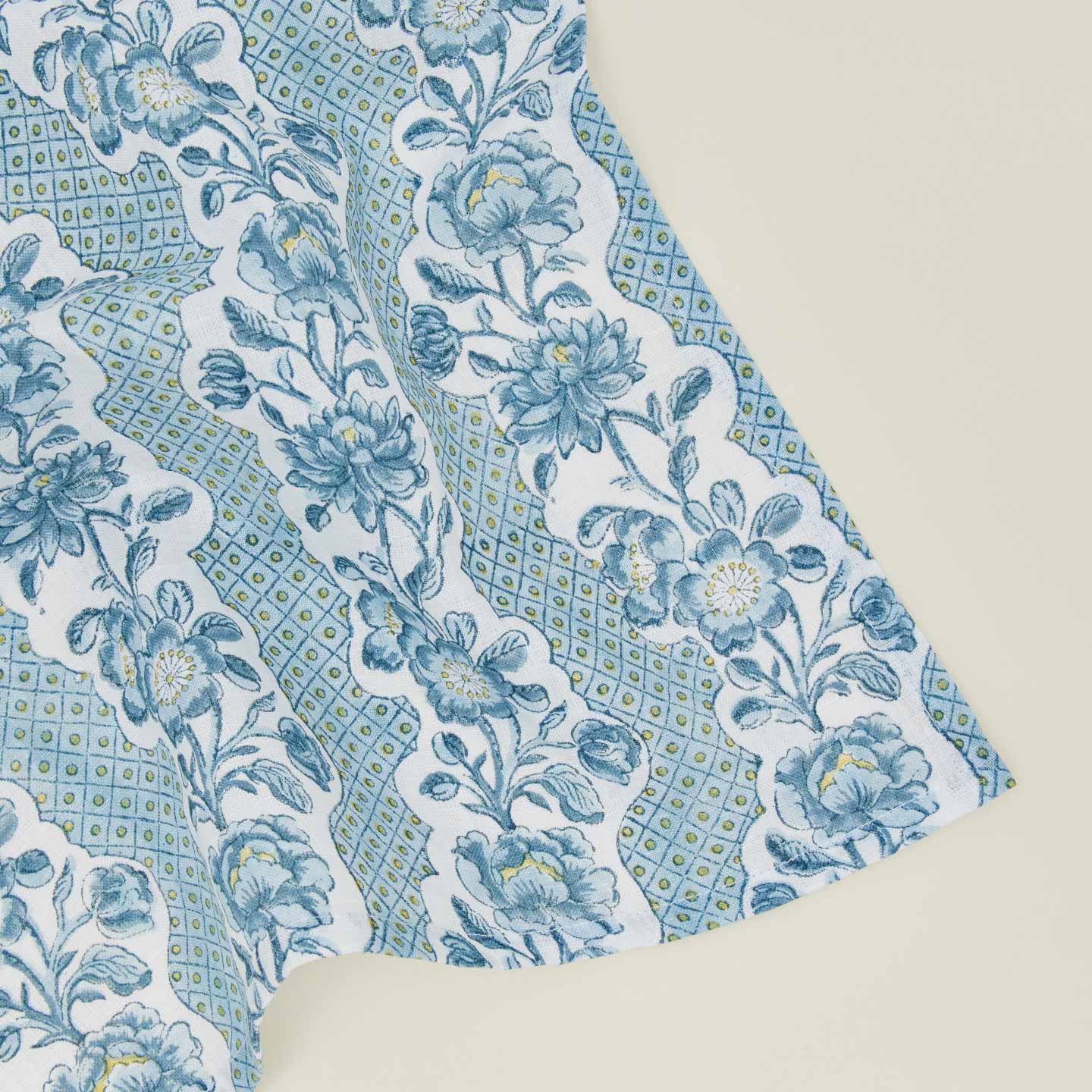 Detail of block printed napkin with a floral pattern in indigo.