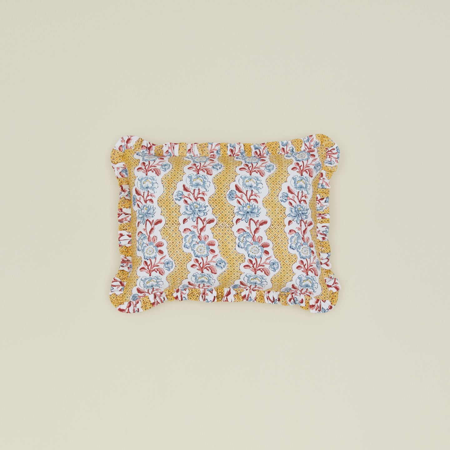 Block printed floral ruffled pillow in mustard.