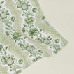 Detail of block printed napkin with a floral pattern in olive.