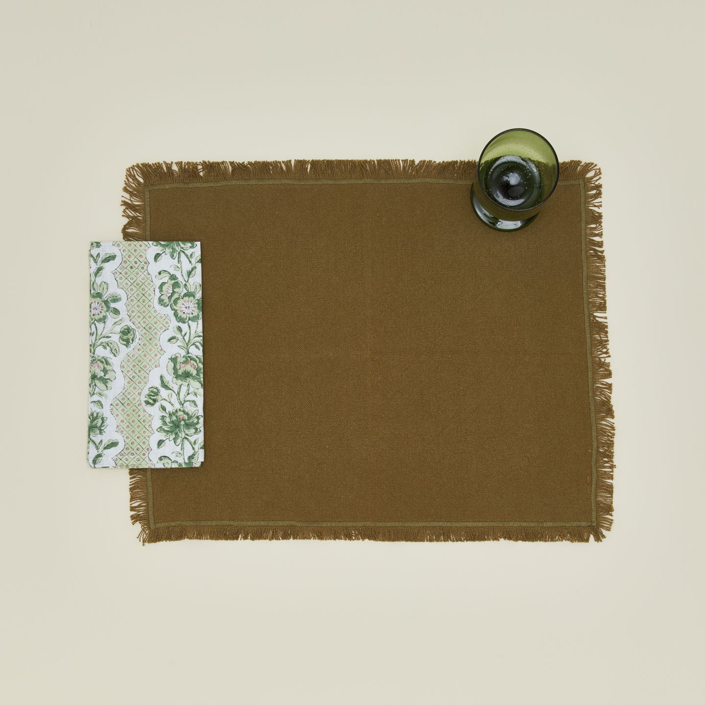 Place setting with block printed floral napkin in olive.