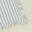 Detail of block printed striped ruffled pillow in olive.